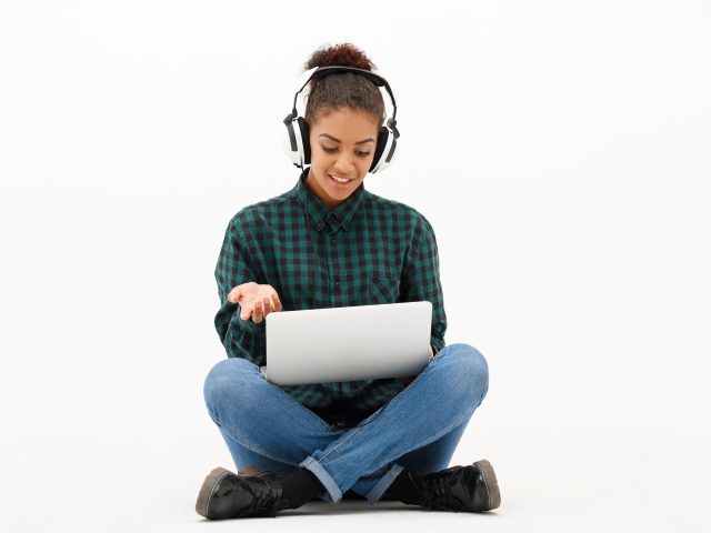 Jente med laptop og headset